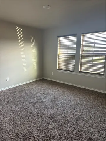 an empty room with a empty space and windows