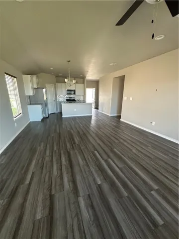 a view of a living room hardwood and kitchen