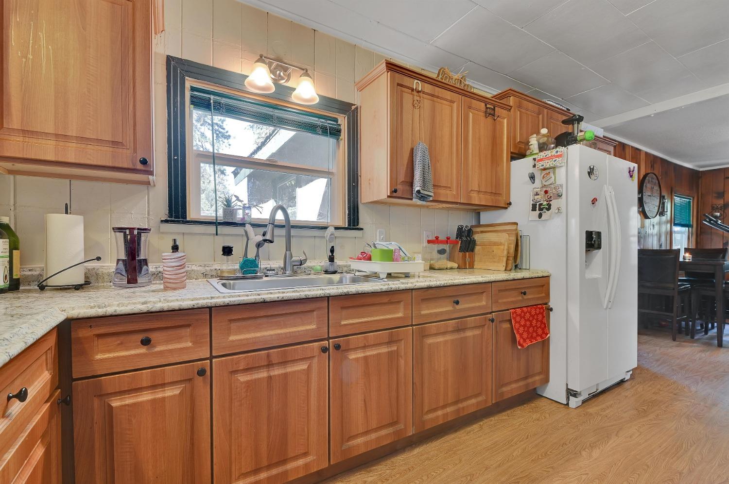6016 Pony Express Trail Pollock Pines, CA 95726 - Photo 13 of 53 a kitchen with stainless steel appliances granite countertop a refrigerator sink and cabinets