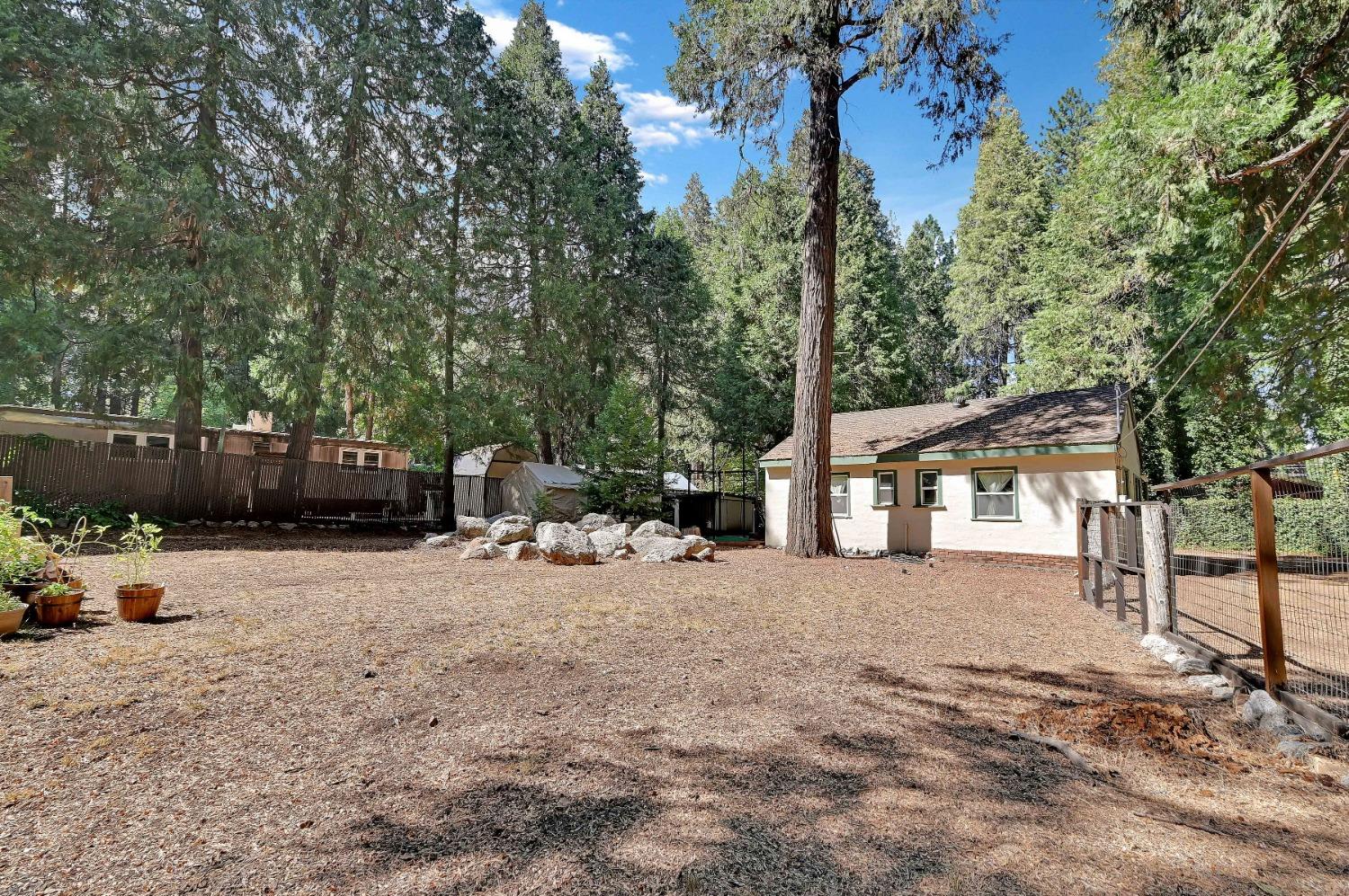 6016 Pony Express Trail Pollock Pines, CA 95726 - Photo 28 of 53 a view of a house with a tree in the background