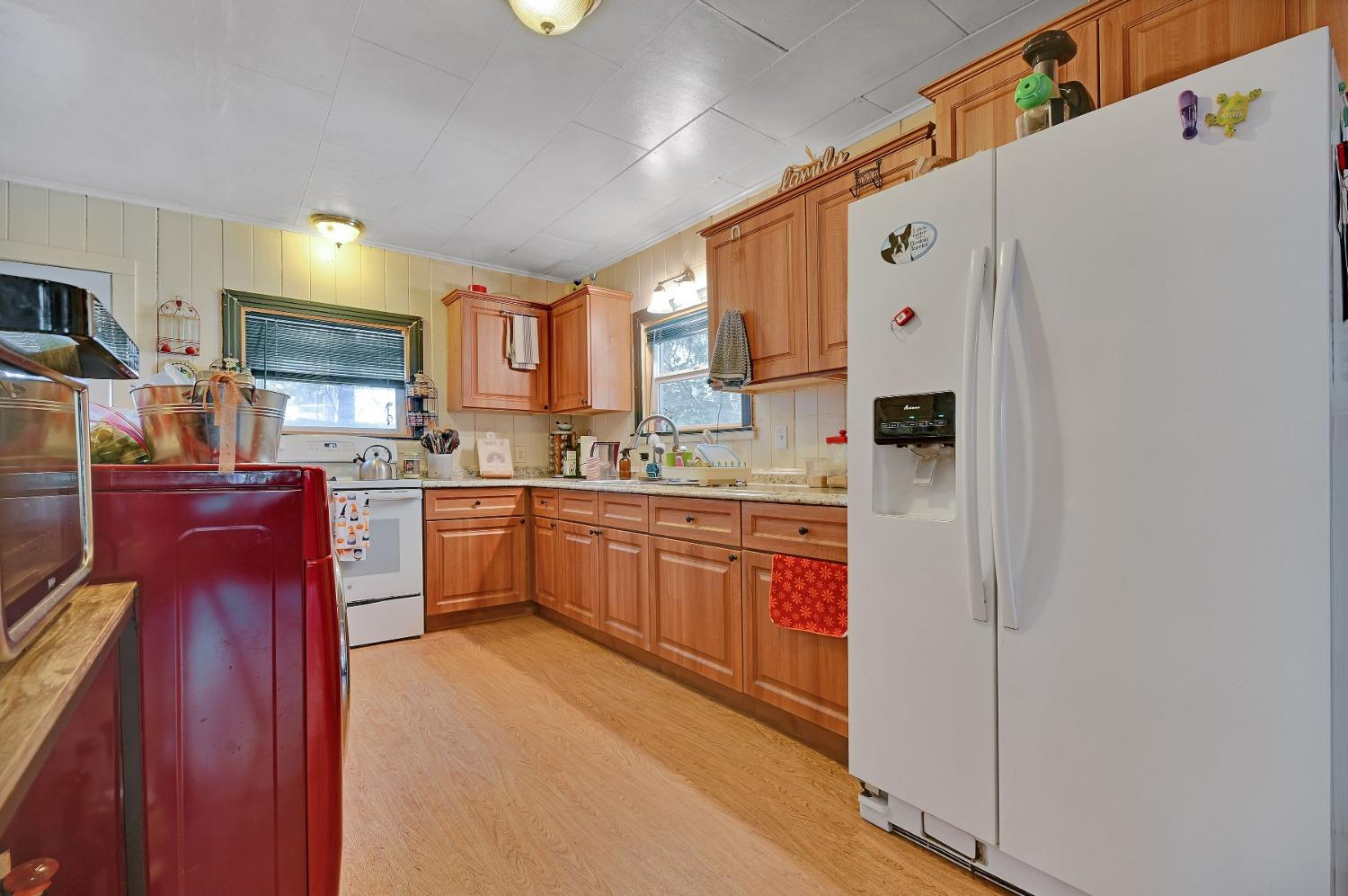 6016 Pony Express Trail Pollock Pines, CA 95726 - Photo 5 of 53 a kitchen with stainless steel appliances granite countertop a refrigerator sink and cabinets