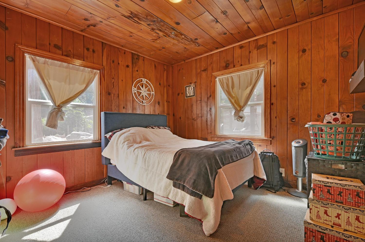 6016 Pony Express Trail Pollock Pines, CA 95726 - Photo 10 of 53 a bed sitting in a bedroom next to a window