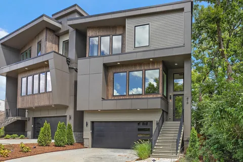 a front view of a house with plants