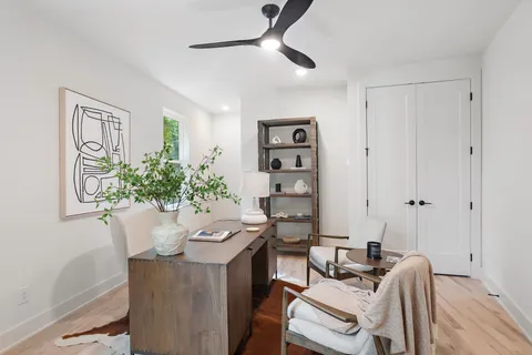 a view of a dining room with furniture and a potted plant