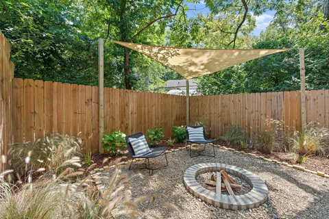 a backyard of a house with table and chairs