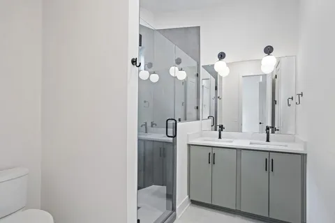 a bathroom with a double vanity sink and mirror