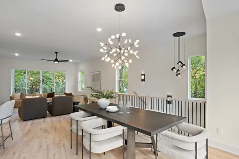 a living room with furniture a chandelier and a window