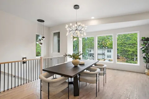 a view of a dining room with furniture a chandelier and wooden floor