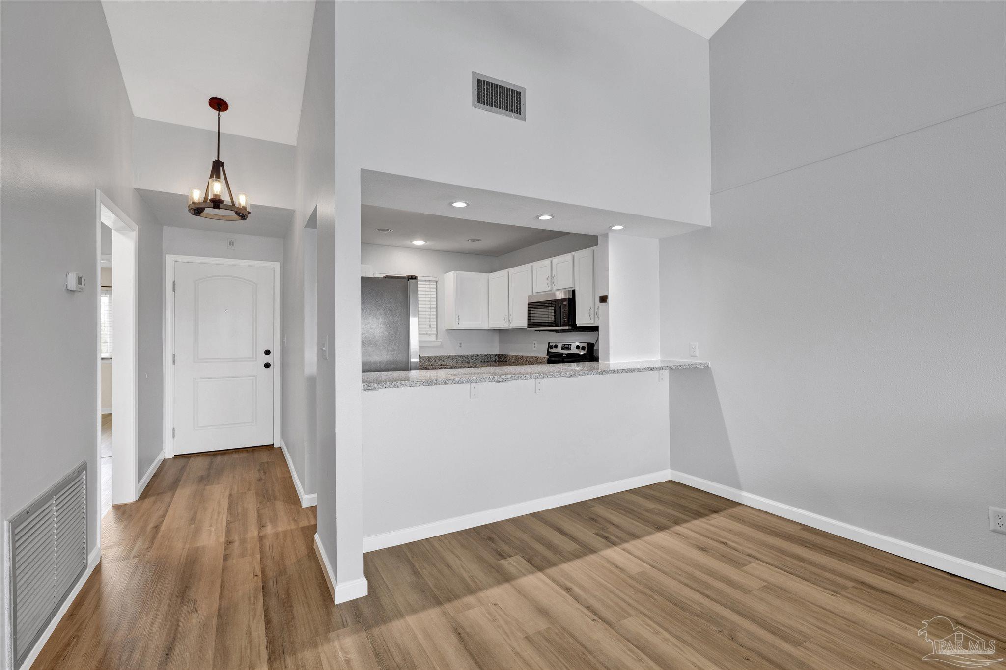 14100 River Road, Unit 334 Perdido Key, FL 32507 - Photo 12 of 35 a view of kitchen and wooden floor