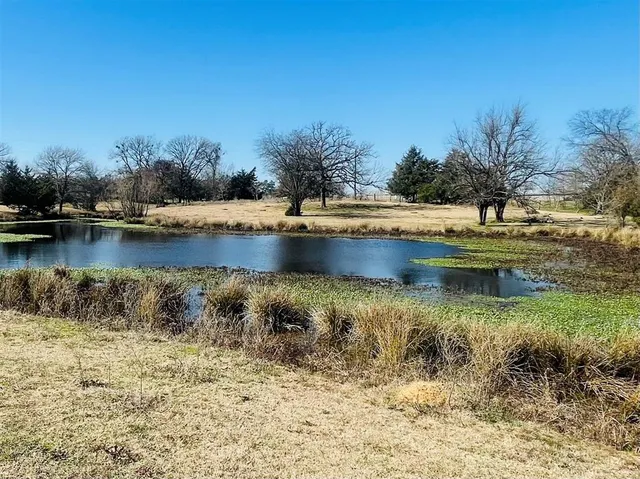 a view of a house with pool and a yard
