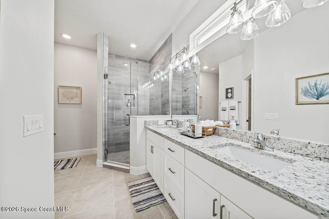 356 Altman Avenue Southeast Palm Bay, FL 32909 - Photo 13 of 27 a bathroom with a double vanity sink mirror and shower