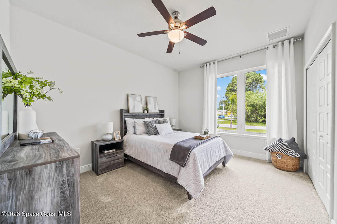 356 Altman Avenue Southeast Palm Bay, FL 32909 - Photo 15 of 27 a bedroom with a bed a couch and a window