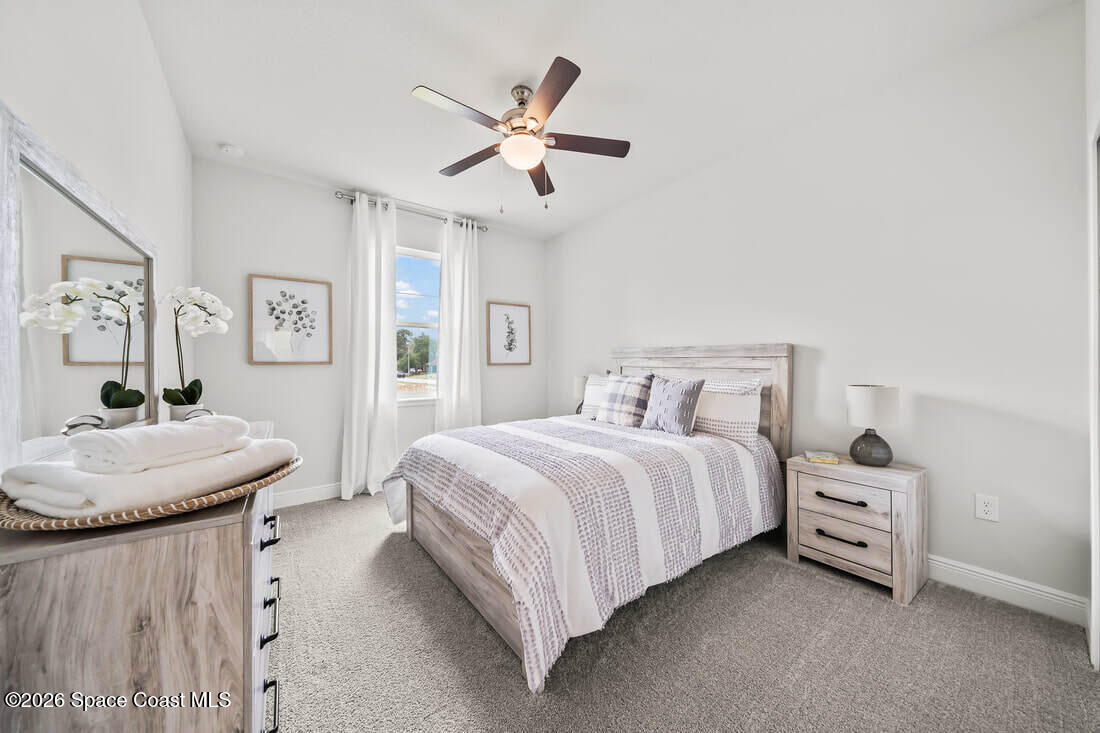 356 Altman Avenue Southeast Palm Bay, FL 32909 - Photo 16 of 27 a bedroom with a bed a bed and a couch
