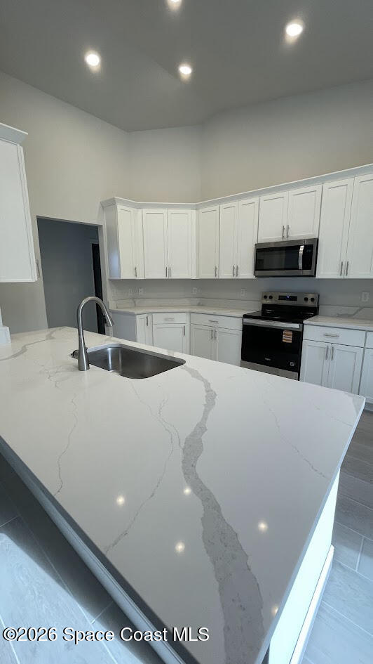 356 Altman Avenue Southeast Palm Bay, FL 32909 - Photo 23 of 27 a white kitchen with sink and white cabinets