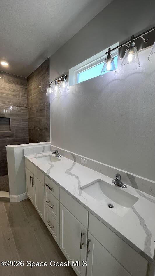 356 Altman Avenue Southeast Palm Bay, FL 32909 - Photo 26 of 27 a bathroom with a double vanity sink and mirror