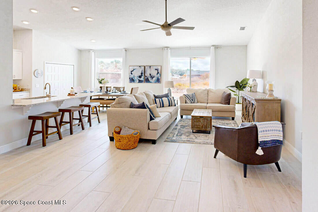 356 Altman Avenue Southeast Palm Bay, FL 32909 - Photo 7 of 27 a living room with furniture and a table