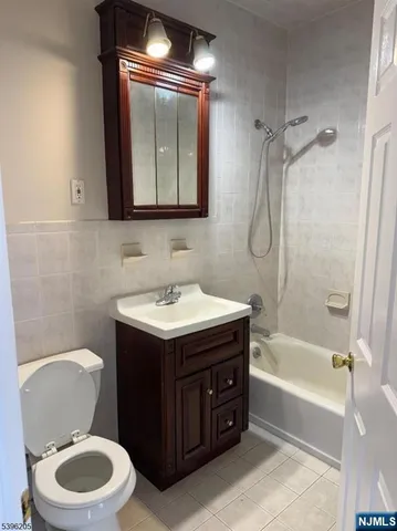 a bathroom with a sink vanity mirror and toilet