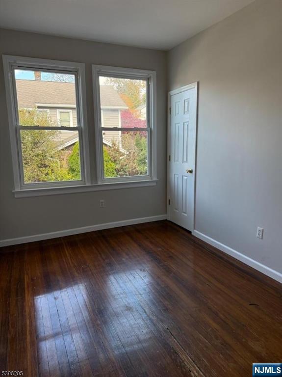 507 Bloomfield Avenue, Unit 2 Nutley, NJ 07110 - Photo 8 of 9 an empty room with wooden floor and windows