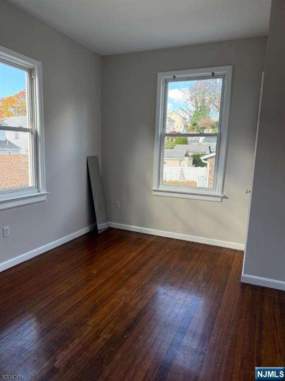 507 Bloomfield Avenue, Unit 2 Nutley, NJ 07110 - Photo 9 of 9 an empty room with wooden floor and windows