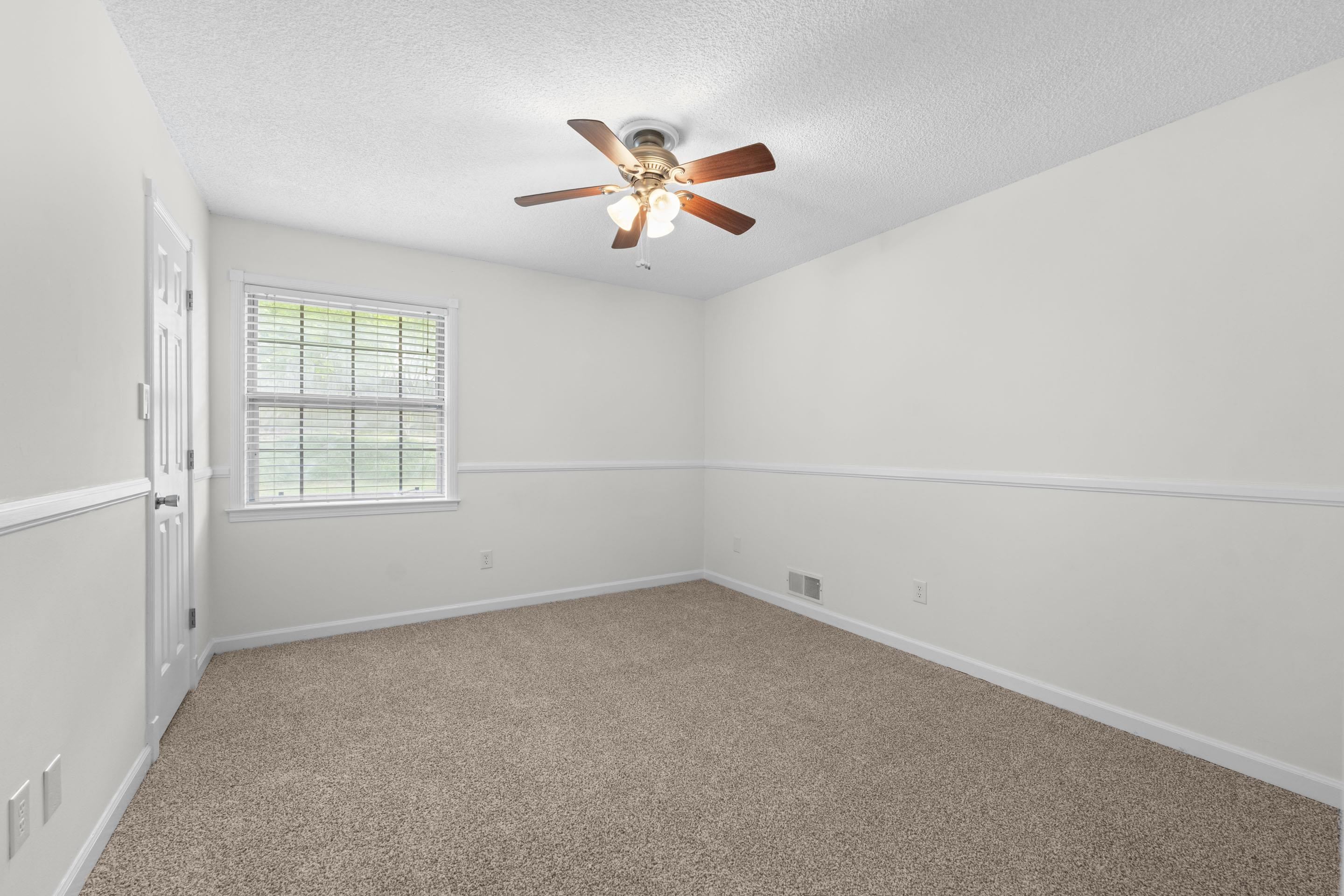 499 Duscoe Street Collierville, TN 38017 - Photo 19 of 38 an empty room with windows and fan