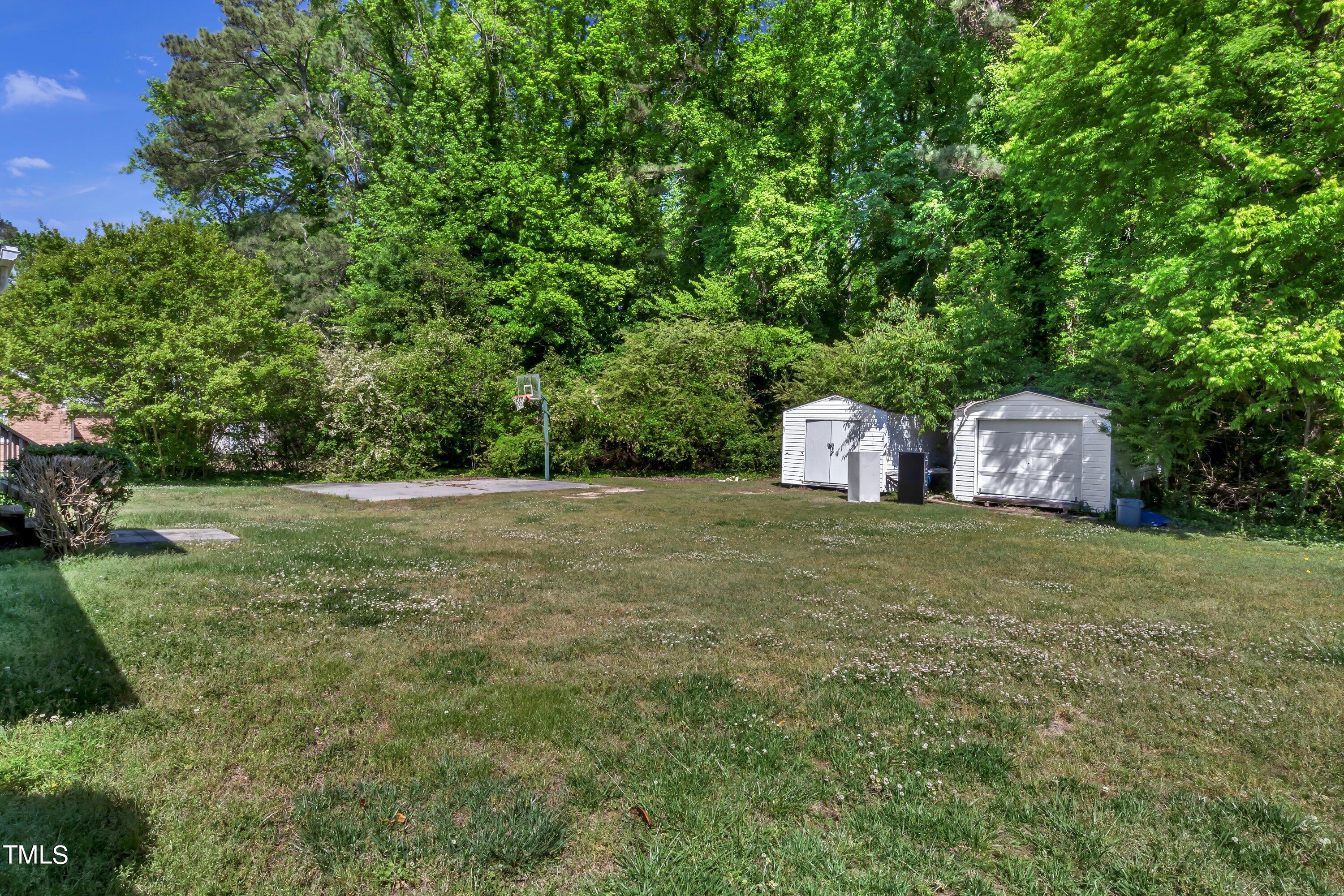 3833 Buffaloe Road Raleigh, NC 27604 - Photo 19 of 25 a front view of a house with a yard and trees