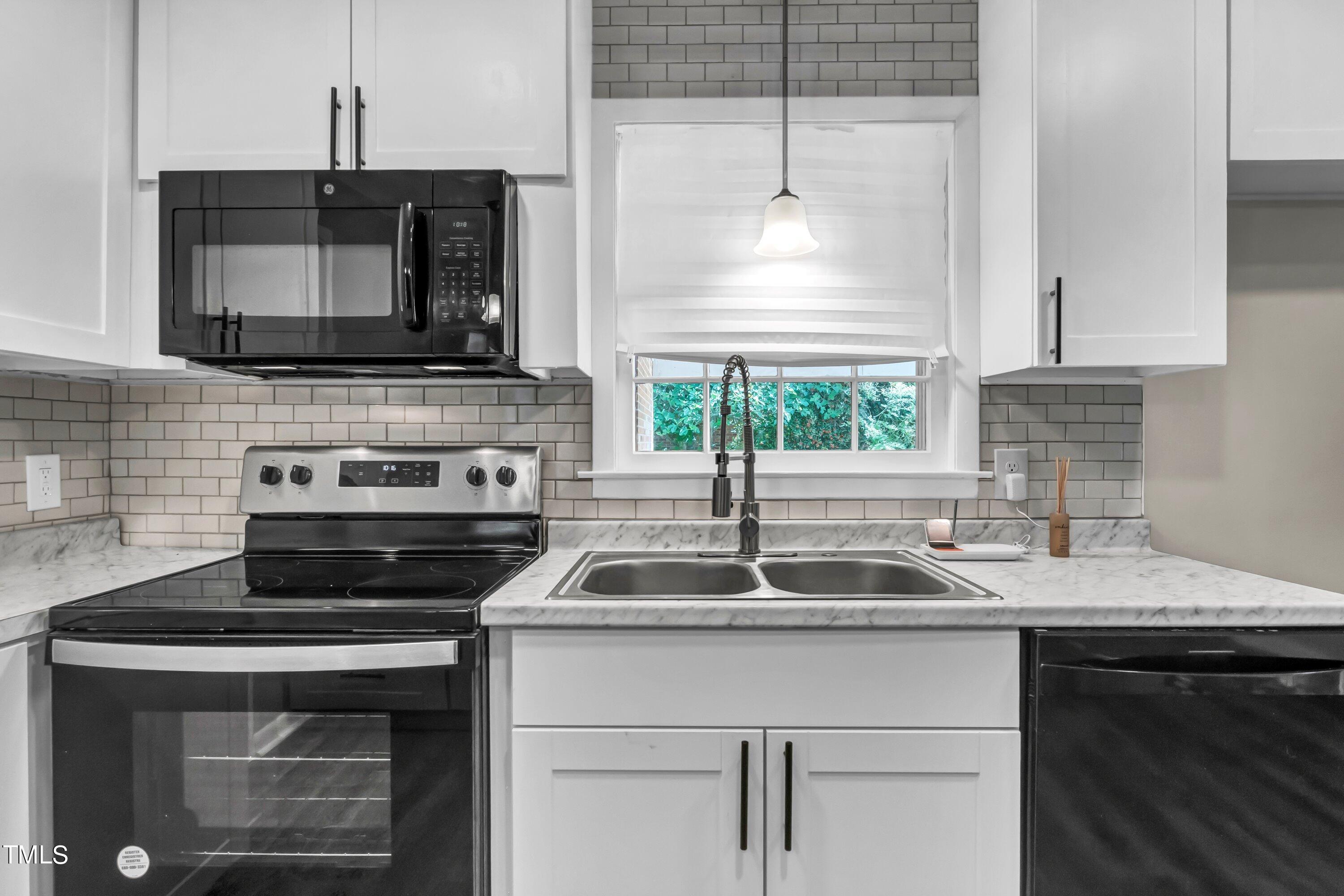 3833 Buffaloe Road Raleigh, NC 27604 - Photo 6 of 25 a kitchen with a sink stove and microwave