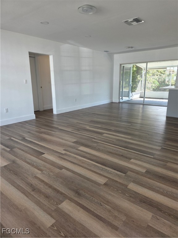 2271 Alton Road Port Charlotte, FL 33952 - Photo 3 of 9 a view of empty room with wooden floor and fan