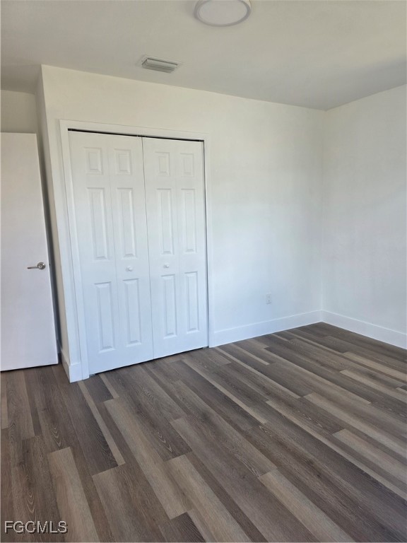 2271 Alton Road Port Charlotte, FL 33952 - Photo 5 of 9 a view of empty room with wooden floor and cabinet