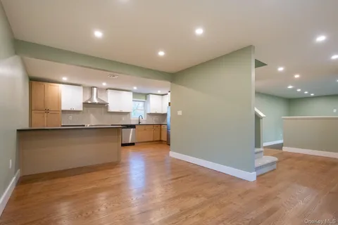 a large kitchen with a large counter top space and stainless steel appliances