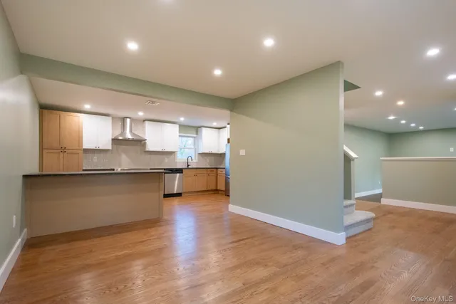 a large kitchen with a large counter top space and stainless steel appliances