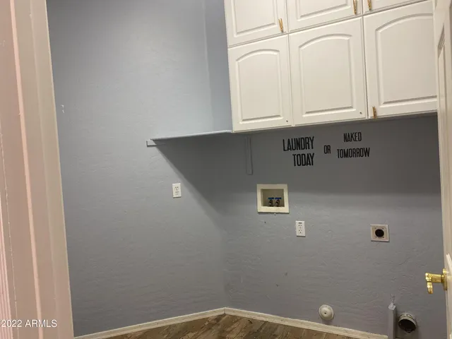 a view of a utility room with granite countertop cabinets