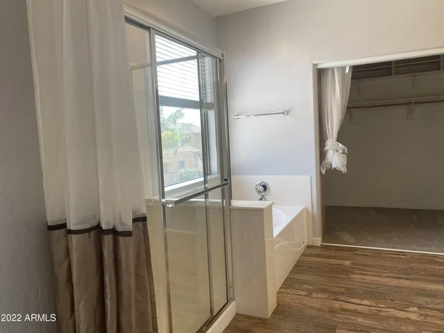 a view of walk in closet with wooden floor