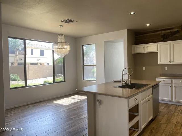 a kitchen that has a sink a window and appliances