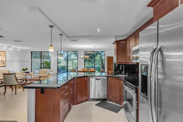 a kitchen with a sink appliances cabinets and furniture