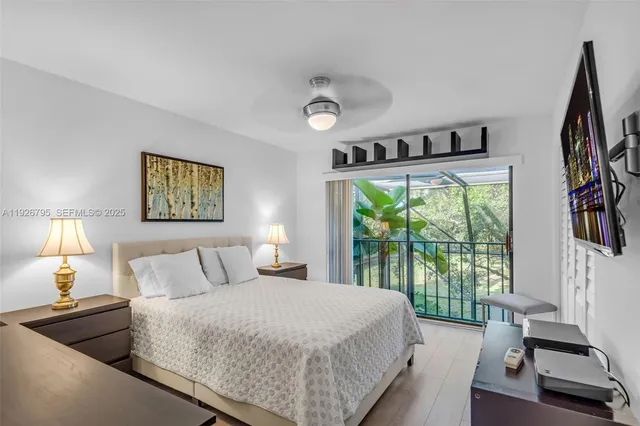 a bedroom with a large bed and a large window