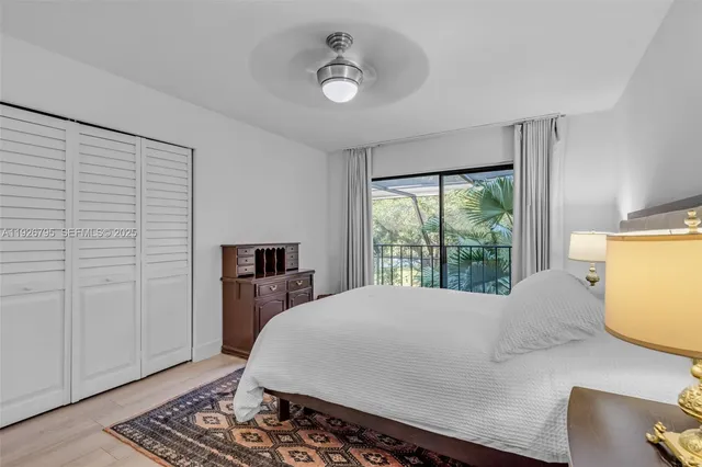 a bed sitting in a spacious bedroom next to a window