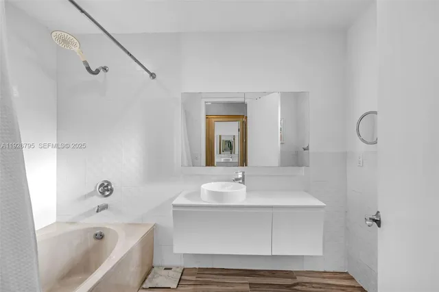 a bathroom with a sink a mirror and a bathtub