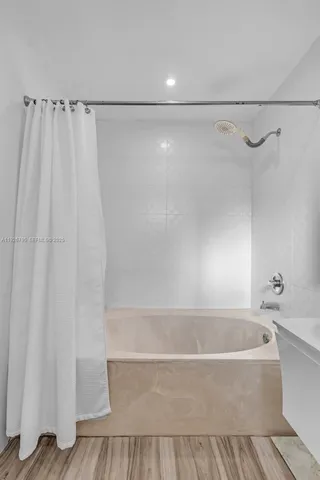 a bathroom with a bathtub and a shower
