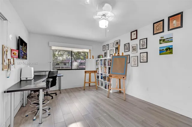 a view of a workspace with furniture and a window