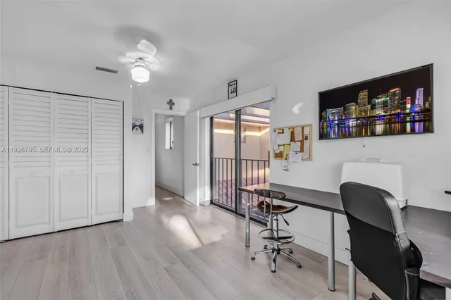 a view of a workspace with furniture and wooden floor