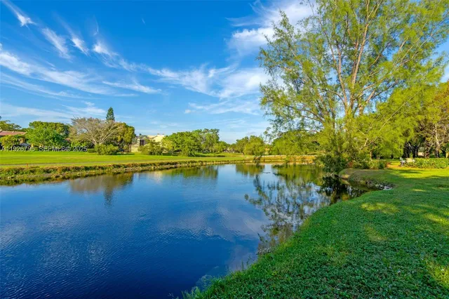 a view of a lake with houses in the back