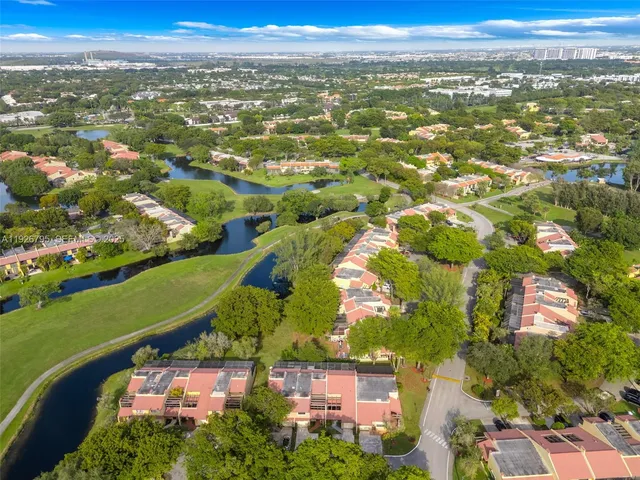 an aerial view of residential building with outdoor space and ocean view