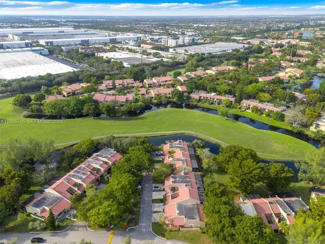 an aerial view of a houses with outdoor space and street view