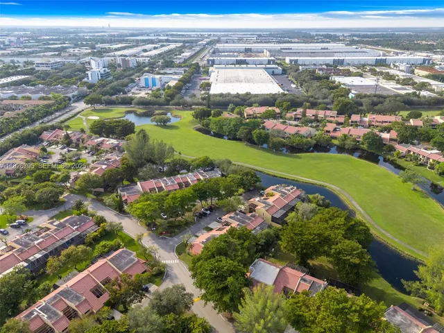 an aerial view of residential building and lake
