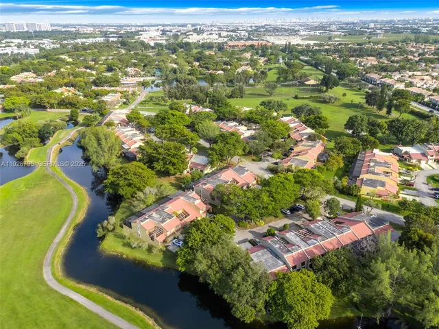 an aerial view of residential houses with outdoor space