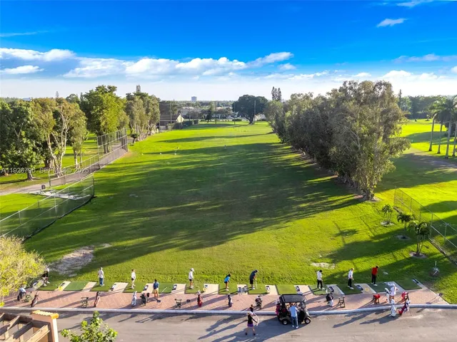 an aerial view of residential houses with outdoor space and swimming pool