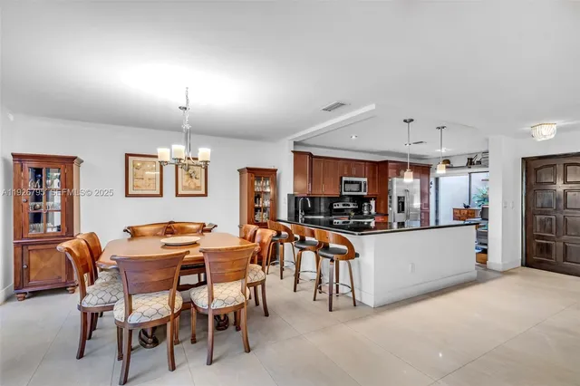 a view of a dining room with furniture and a kitchen