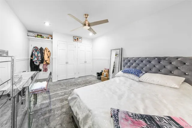 a bedroom with a bed and a chair