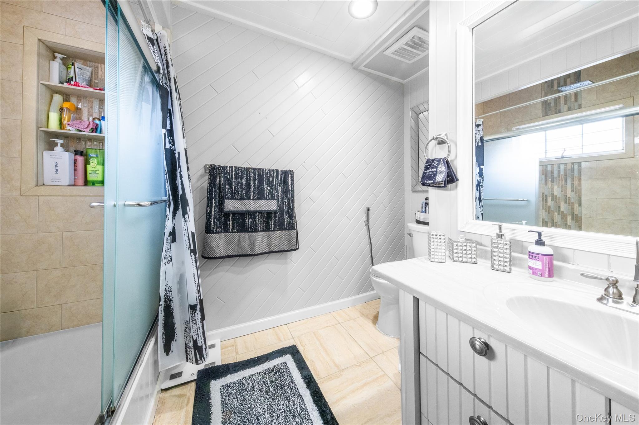 166-02 76th Avenue Queens, NY 11366 - Photo 21 of 28 a bathroom with a sink a vanity and a mirror