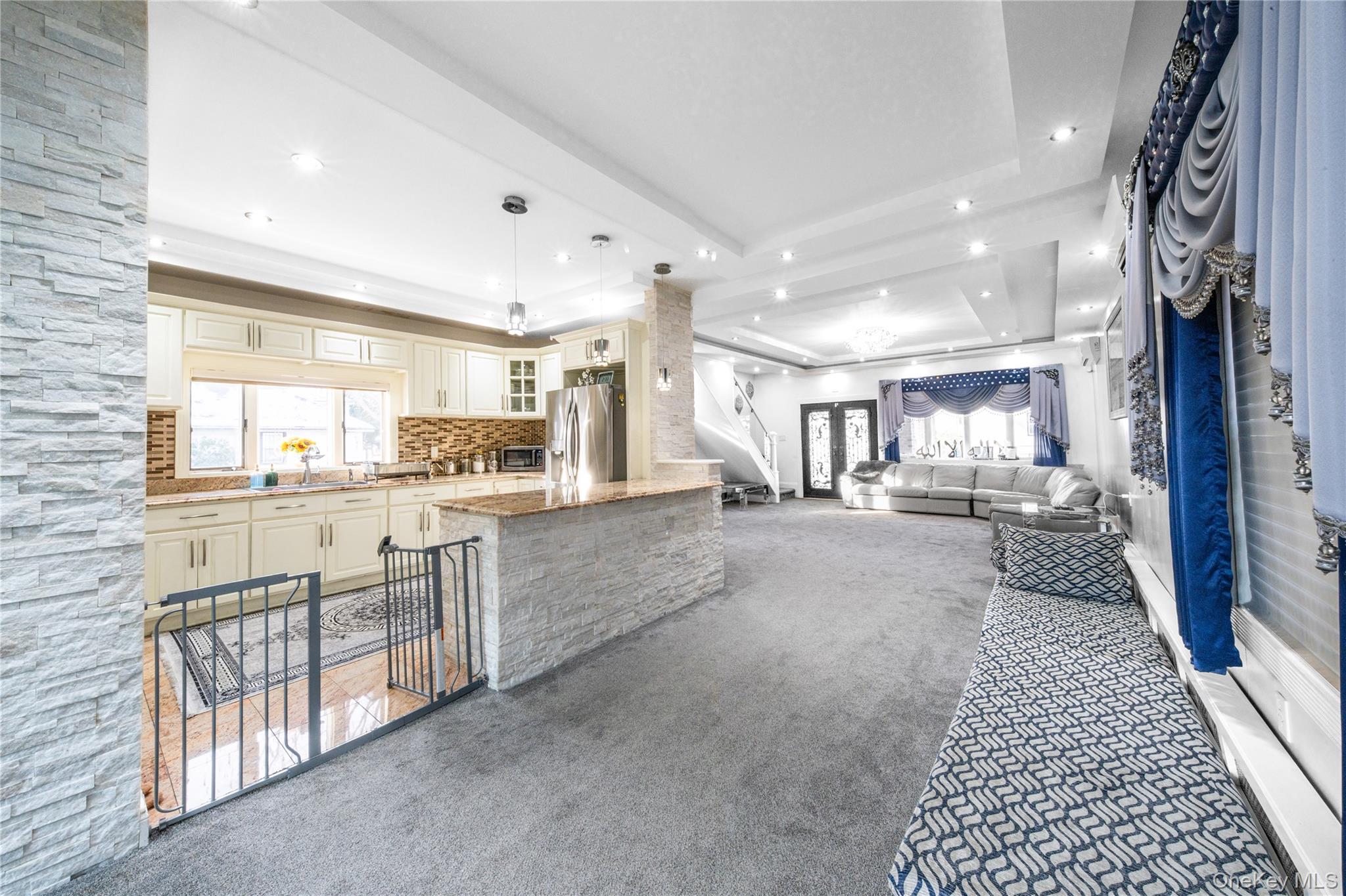 166-02 76th Avenue Queens, NY 11366 - Photo 5 of 28 a kitchen with white cabinets and stainless steel appliances